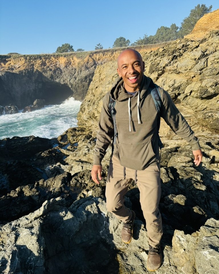 Anthony Booker on the rocks above the ocean