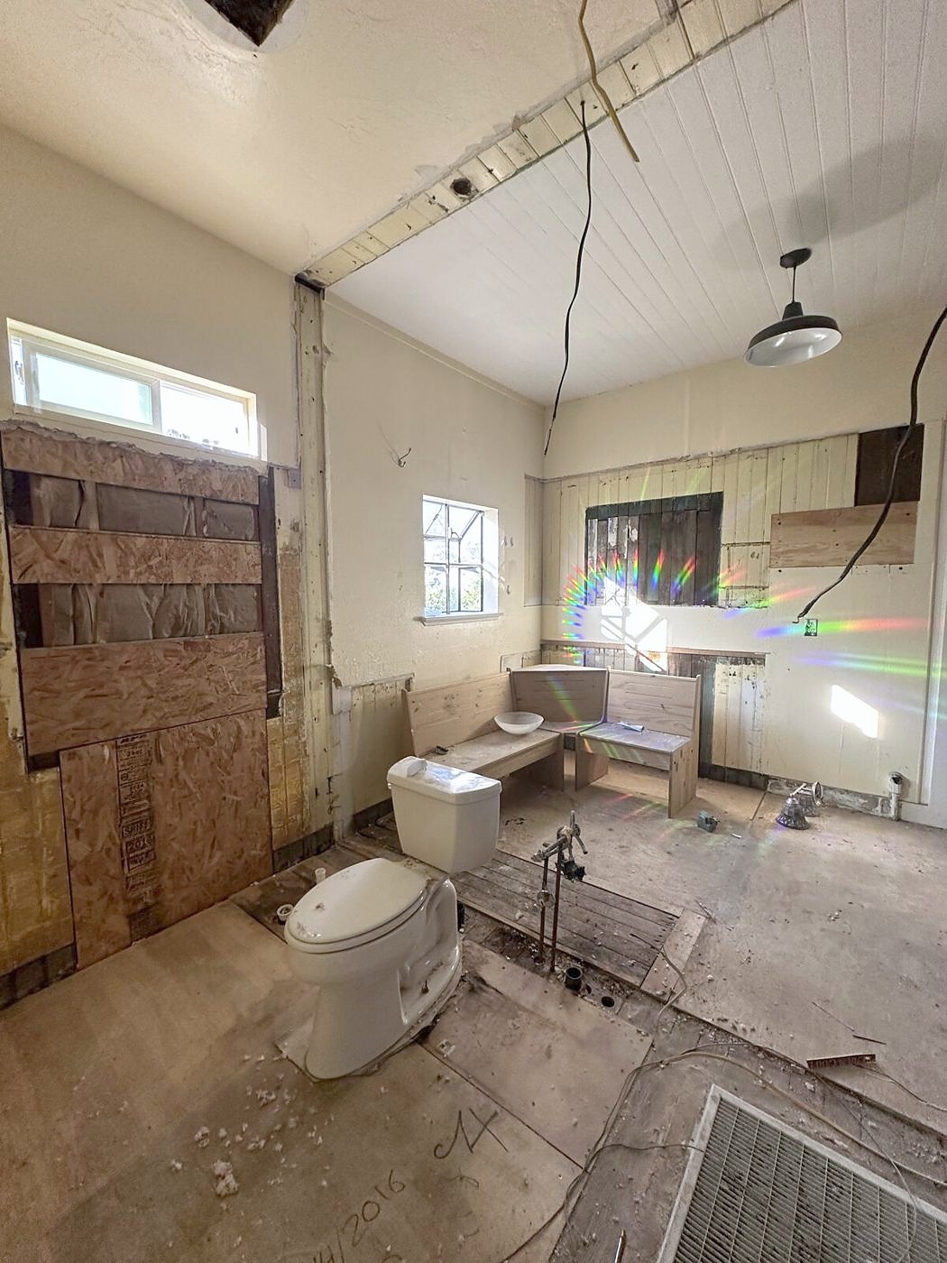 The old bathroom stripped to the studs and subfloor