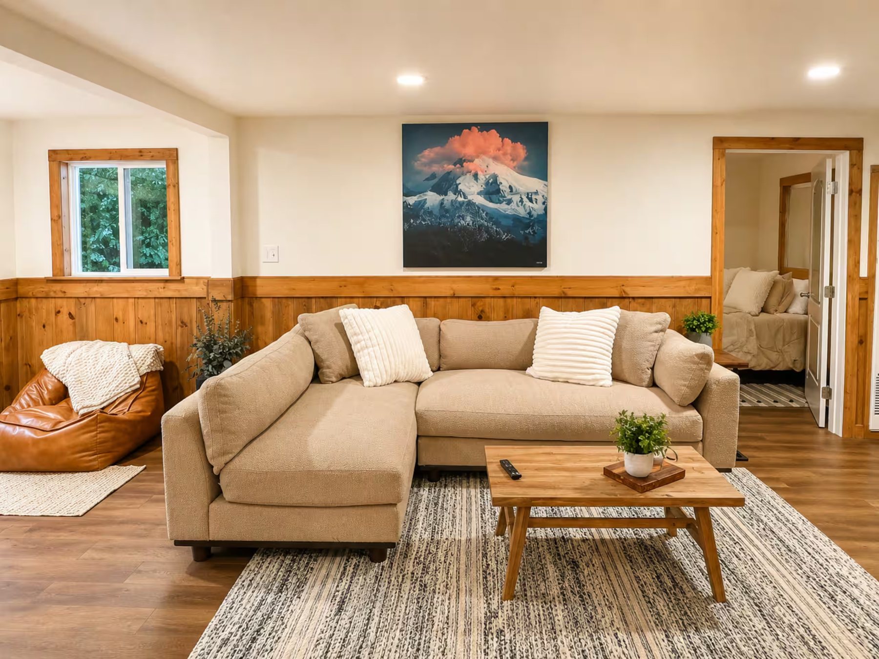 The living room with pine wainscot and a sectional