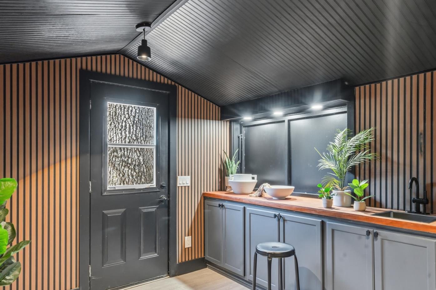 Inside the bar, slatted wood walls and a dark ceiling
