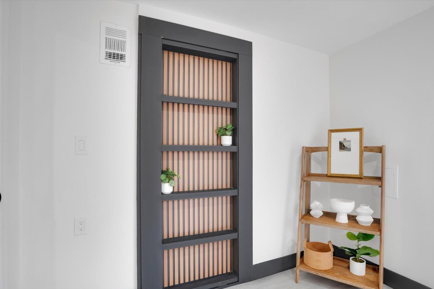 The hidden door closed, reading as slatted shelving