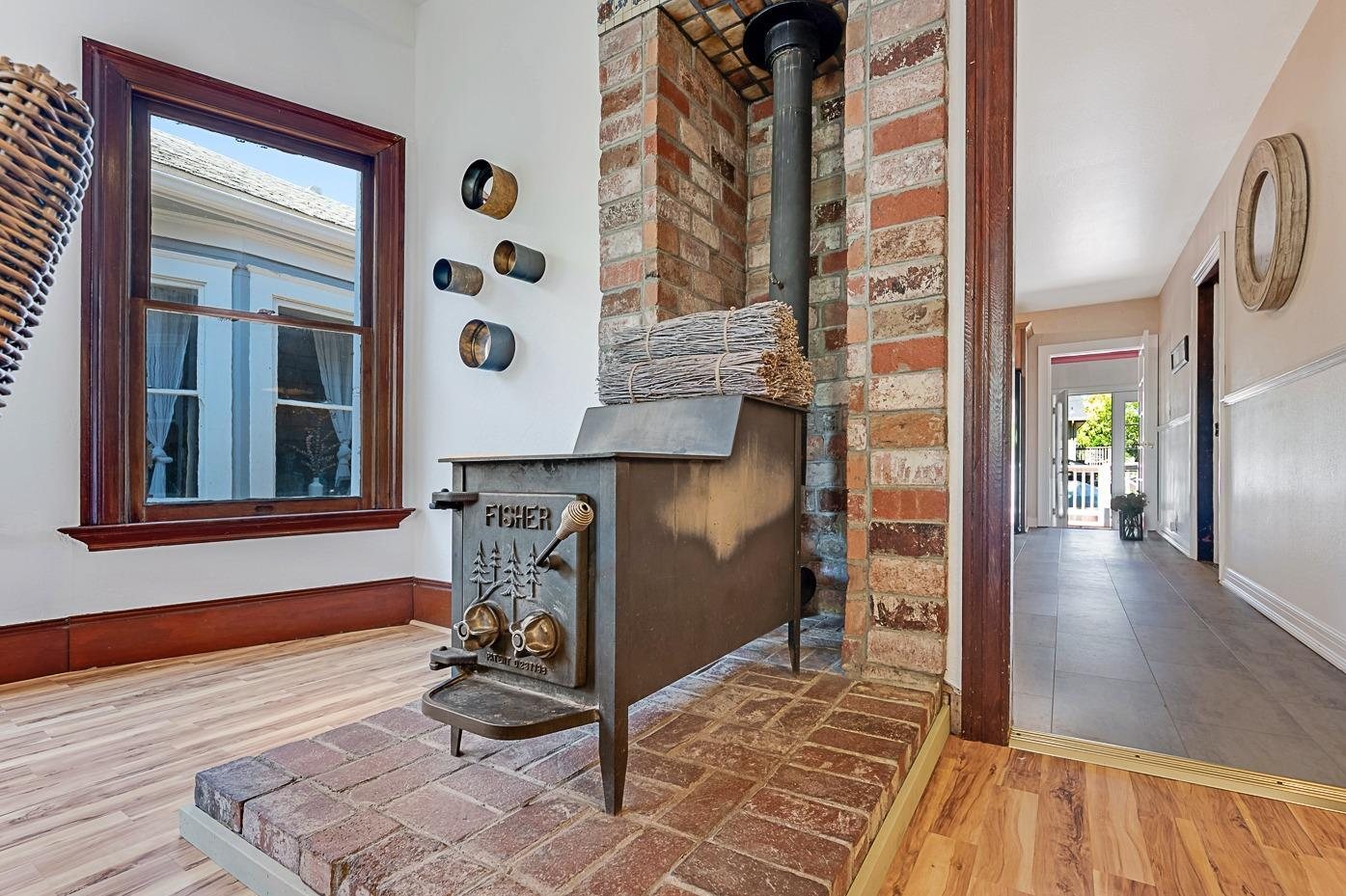 The brick wood stove before, with dark-stained trim